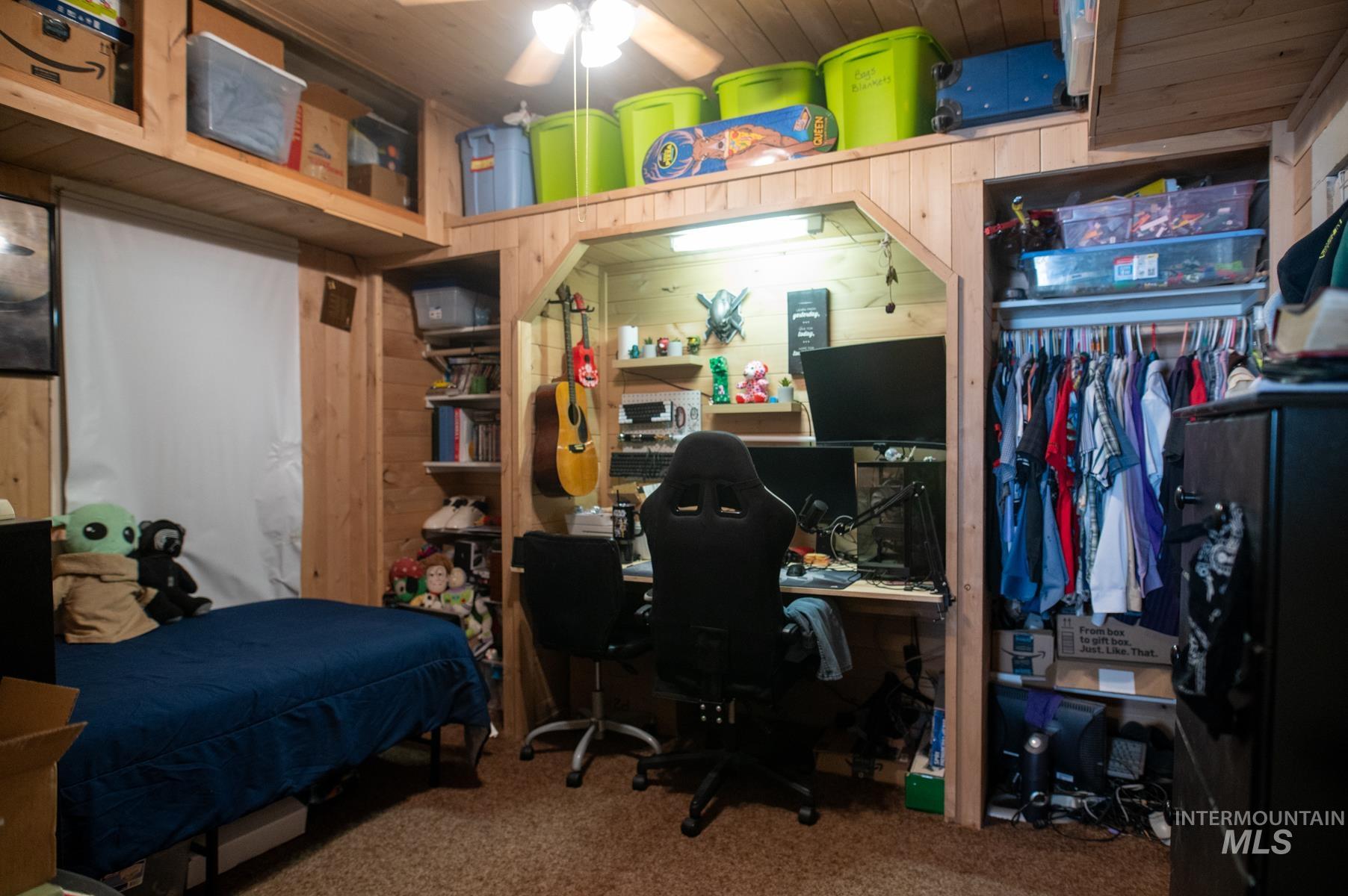 736 East Main Street Weiser, ID 83672 - Photo 28 of 33 Wood-paneled room featuring a built-in desk area with overhead lighting, a ceiling fan, and integrated open shelving