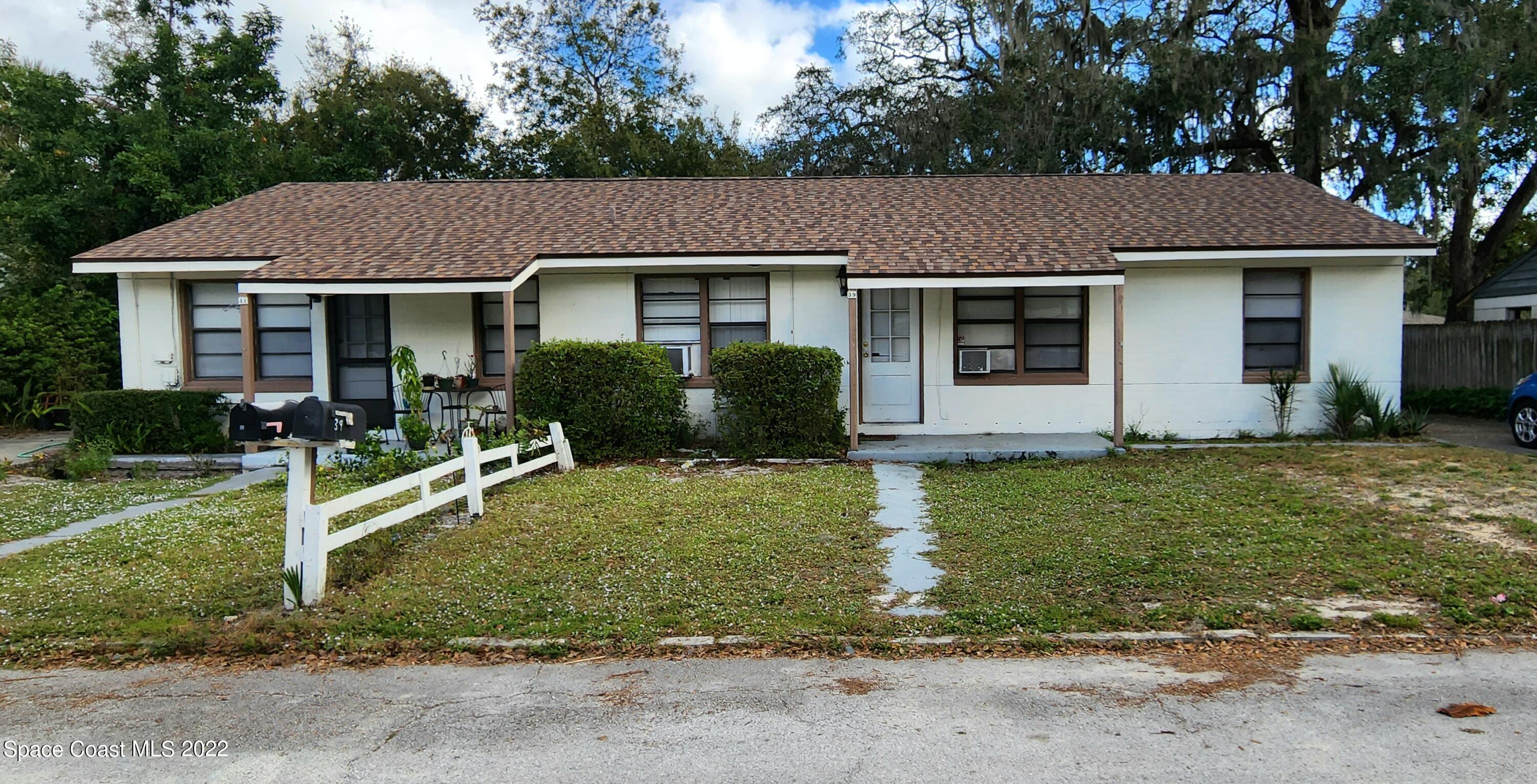39-41 Patrick Lane, Unit A & B Rockledge, FL 32955 - Photo 1 of 22 a front view of a house with a yard