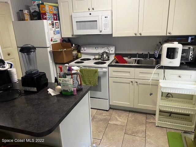 39-41 Patrick Lane, Unit A & B Rockledge, FL 32955 - Photo 14 of 22 a kitchen with a sink appliances and cabinets