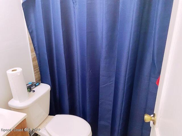 39-41 Patrick Lane, Unit A & B Rockledge, FL 32955 - Photo 16 of 22 a white toilet sitting next to a wooden cabinet