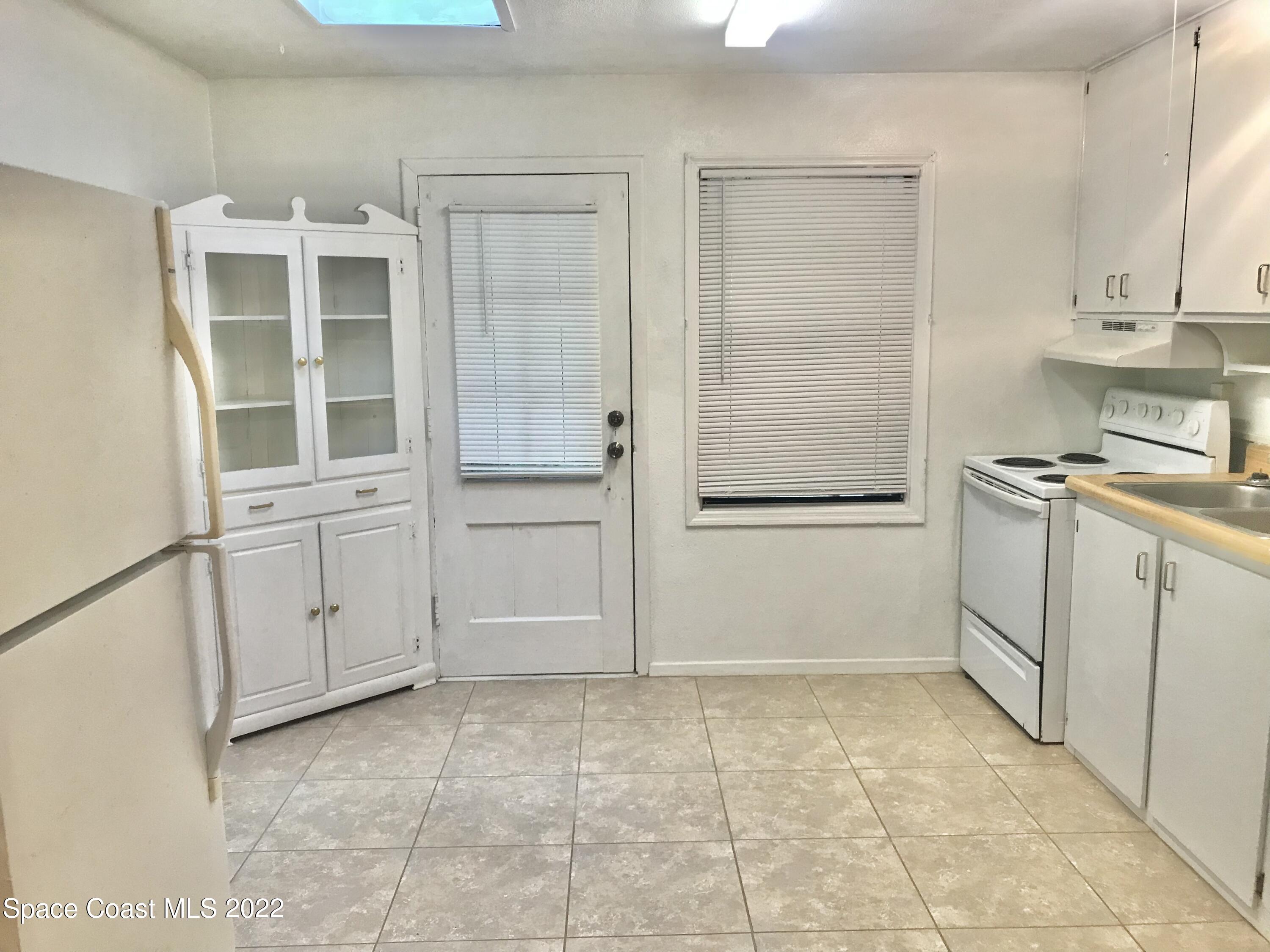 39-41 Patrick Lane, Unit A & B Rockledge, FL 32955 - Photo 4 of 22 a view of a kitchen with white cabinets