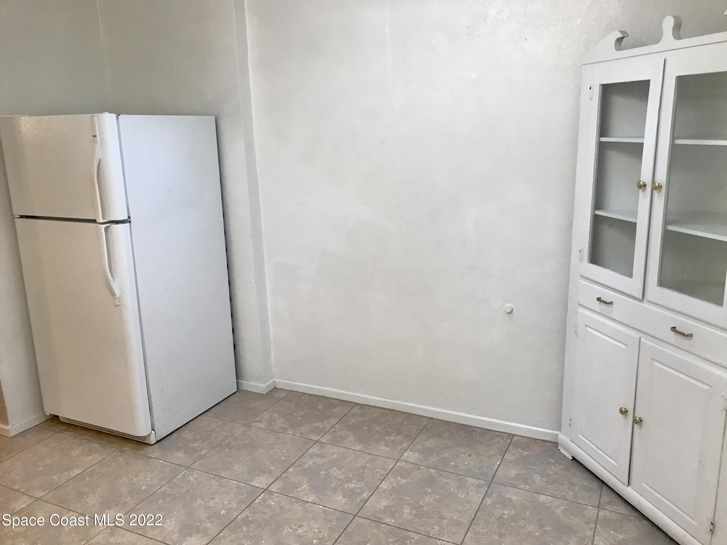 39-41 Patrick Lane, Unit A & B Rockledge, FL 32955 - Photo 5 of 22 a view of cabinets and refrigerator