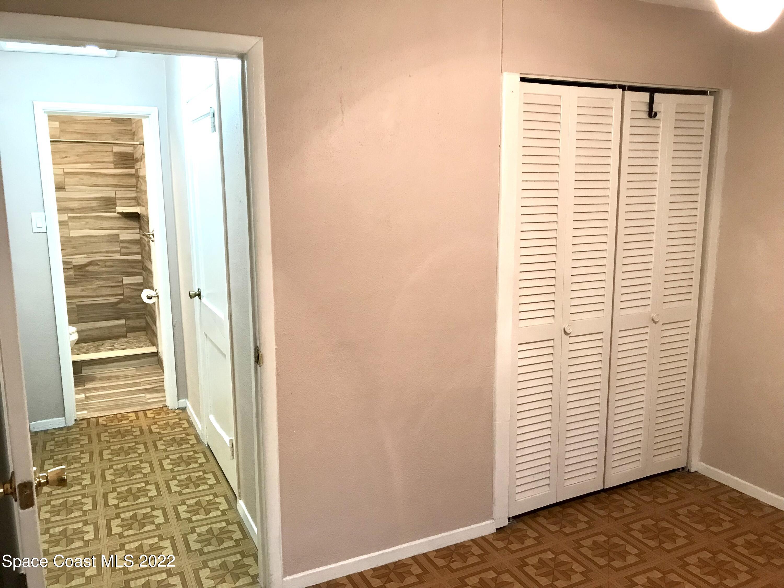 39-41 Patrick Lane, Unit A & B Rockledge, FL 32955 - Photo 7 of 22 a view of a bedroom with wooden floor and a window