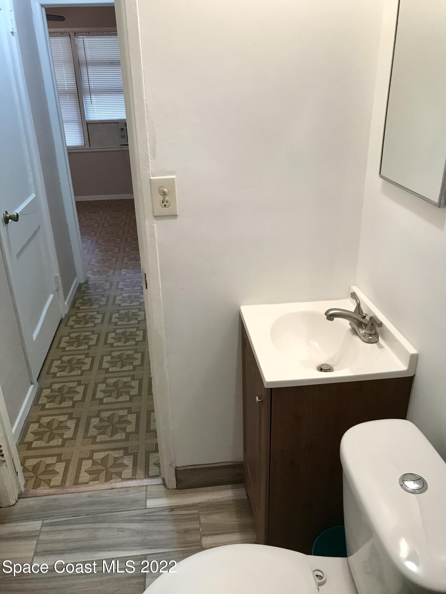 39-41 Patrick Lane, Unit A & B Rockledge, FL 32955 - Photo 10 of 22 a bathroom with sink and mirror