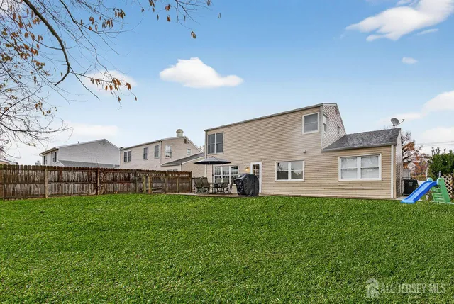 a view of a house with a yard and sitting area