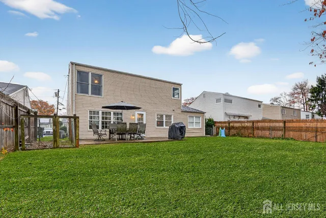 a view of a house with a yard and sitting area