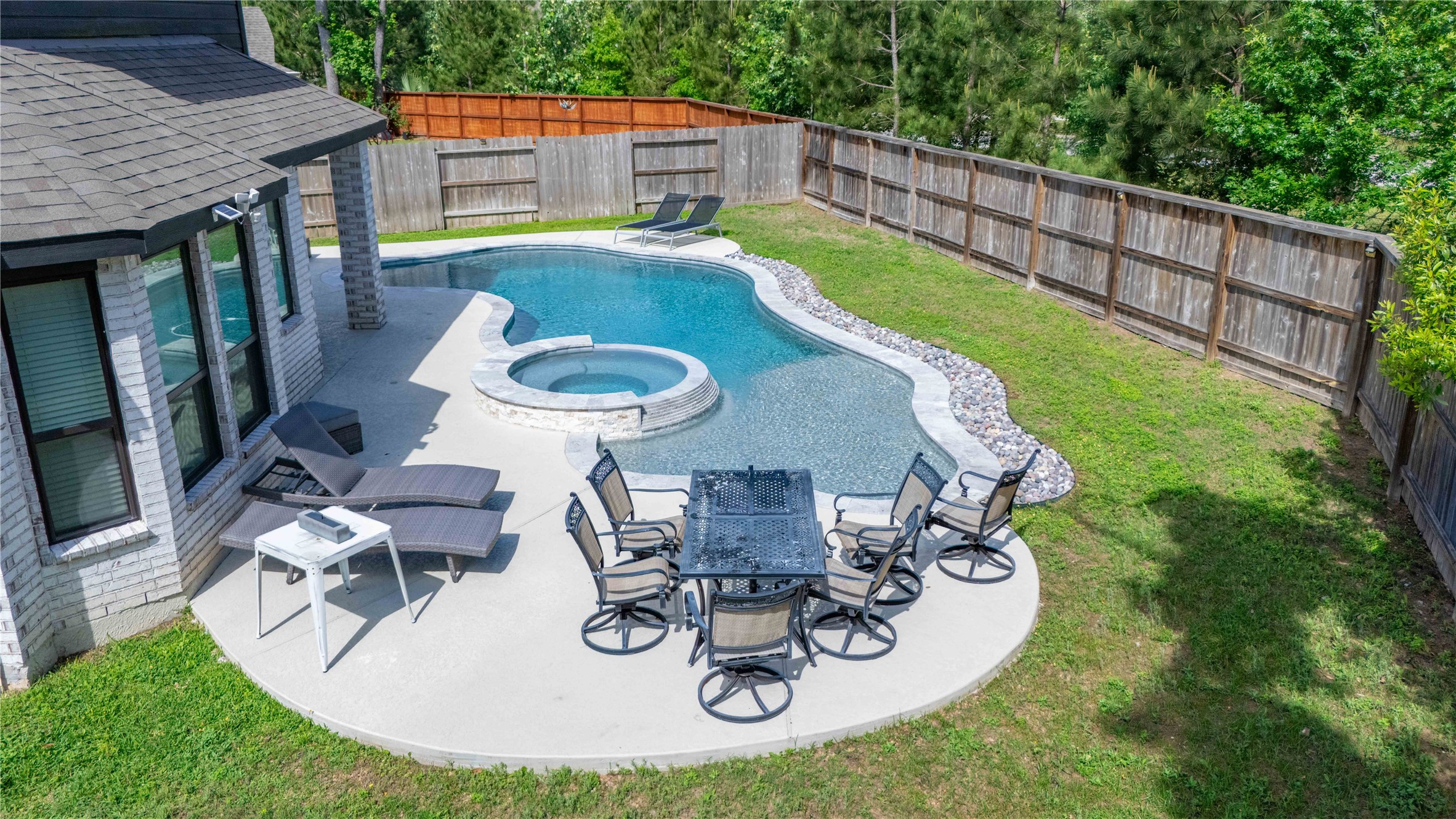 527 Chestnut Reef Court Conroe, TX 77304 - Photo 35 of 40 a view of a swimming pool with back yard of the house