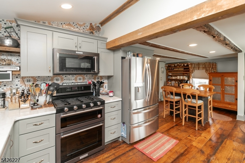 36 Main Street Flanders, NJ 07836 - Photo 11 of 49 a kitchen with granite countertop a refrigerator and a stove top oven