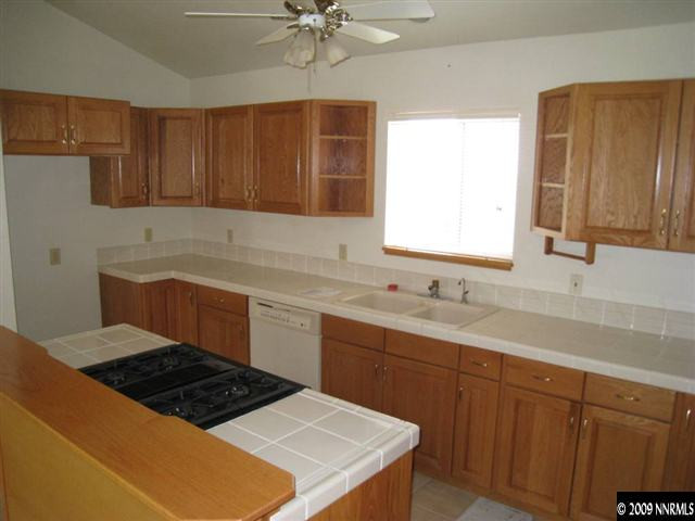 21380 Graves Road Reno, NV 89521 - Photo 3 of 6 a kitchen with a sink stove and cabinets