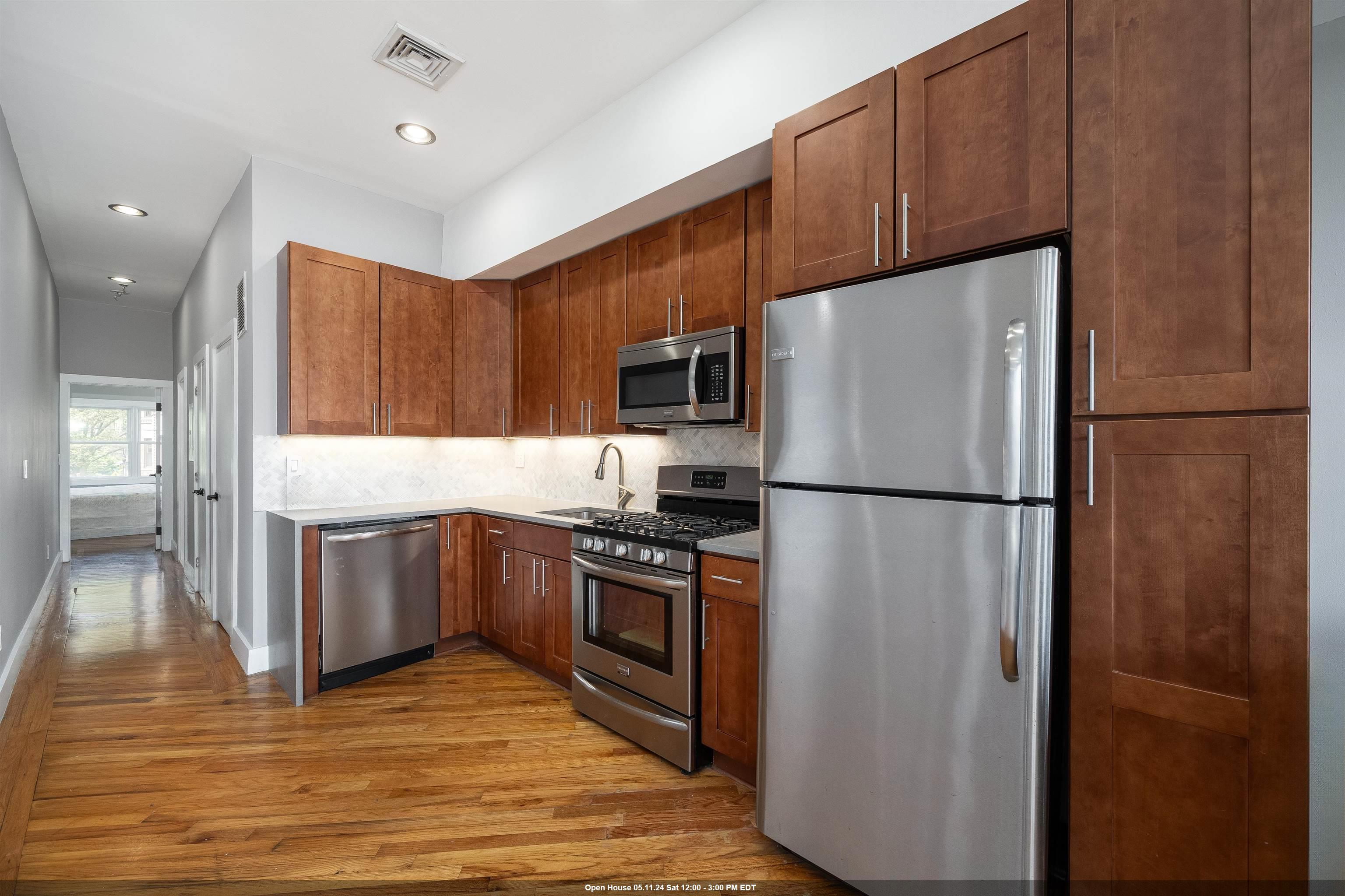 a kitchen with stainless steel appliances granite countertop a refrigerator microwave and stove