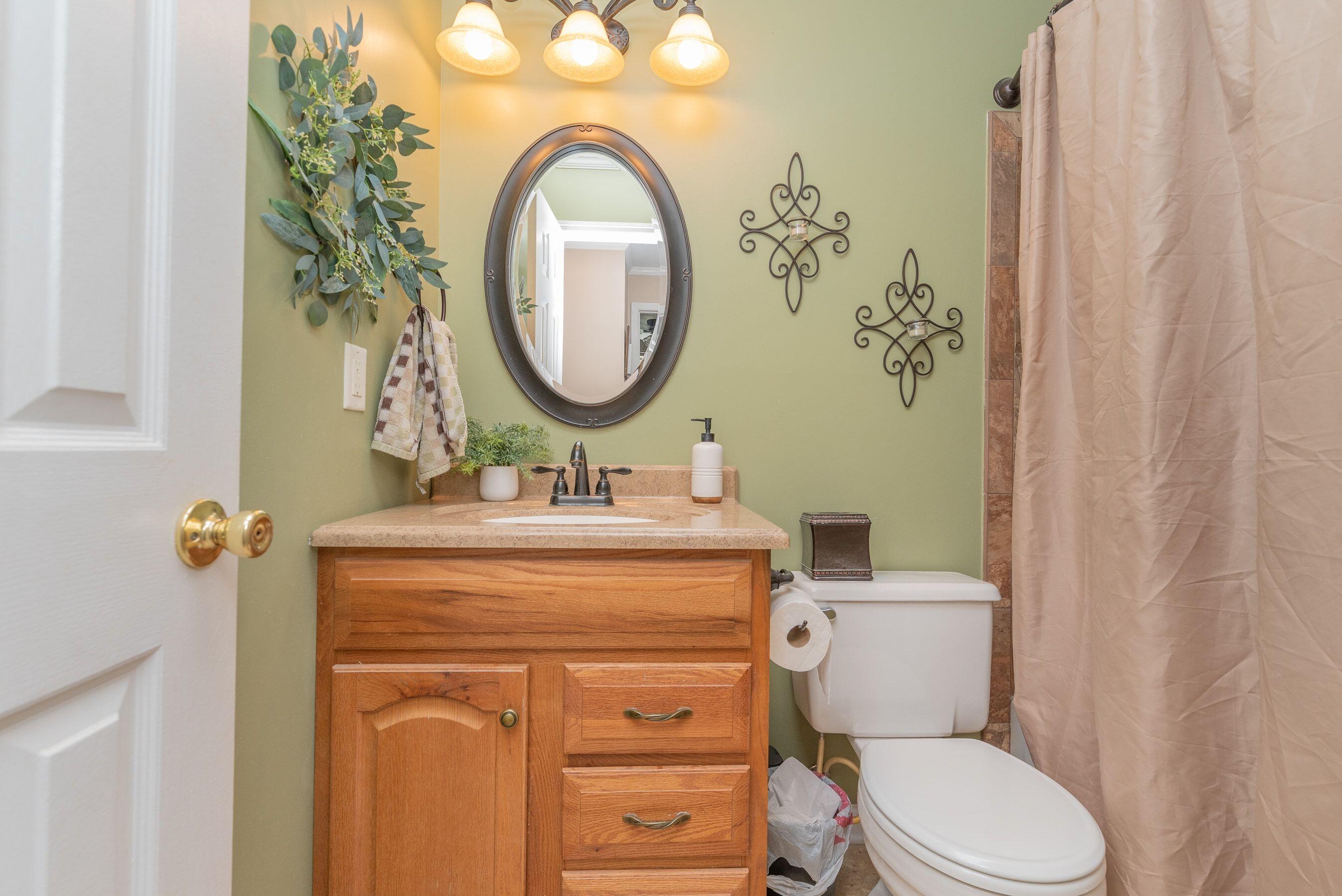 1117 Ridgemont Drive Aiken, SC 29803 - Photo 19 of 49 a bathroom with a granite countertop toilet sink and mirror