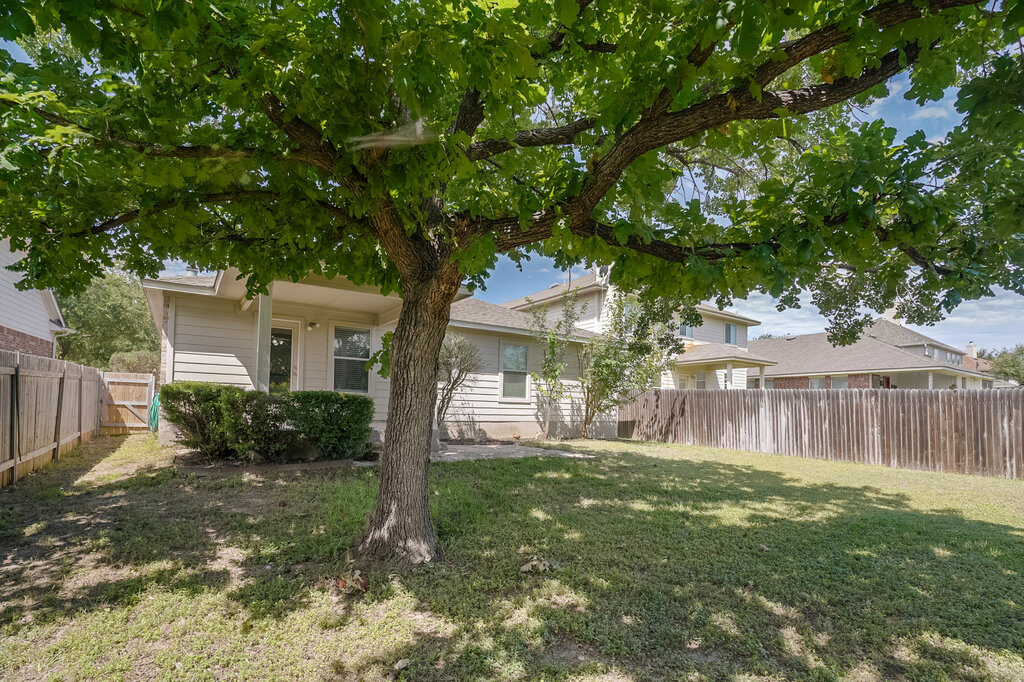 2724 Kickapoo Cavern Drive Pflugerville, TX 78660 - Photo 23 of 24 A spacious, fenced backyard offers a mature shade tree and ample room for recreation.
