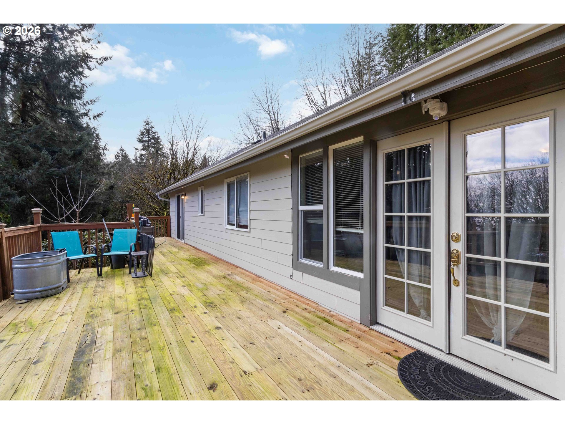 421 McAdams Road East Longview, WA 98632 - Photo 3 of 40 a view of house with backyard outdoor seating and covered with tall trees