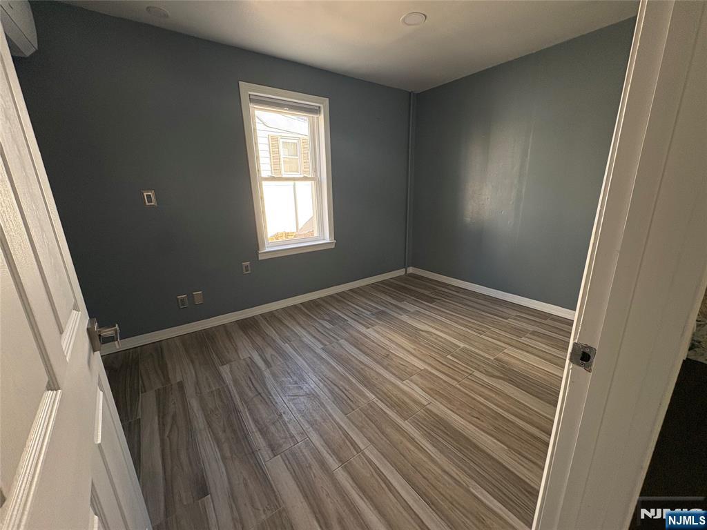 282 Harding Avenue, Unit 1 Teaneck, NJ 07666 - Photo 12 of 21 a view of room with window and hardwood floor