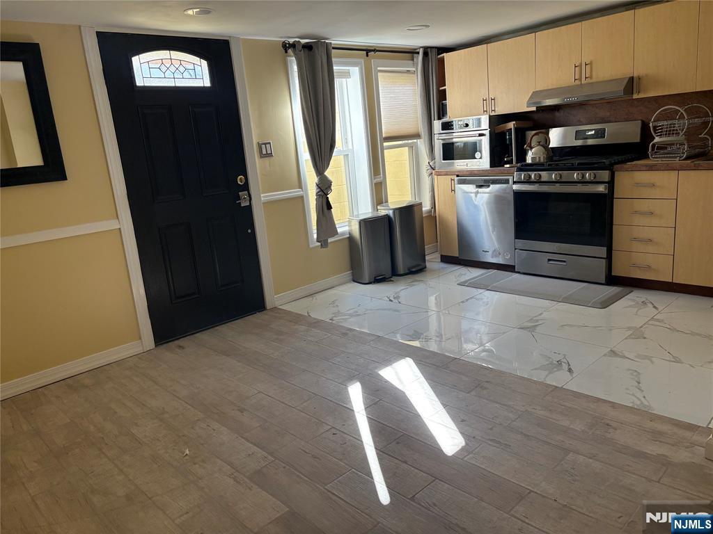 282 Harding Avenue, Unit 1 Teaneck, NJ 07666 - Photo 18 of 21 a kitchen with stainless steel appliances granite countertop a refrigerator stove and sink