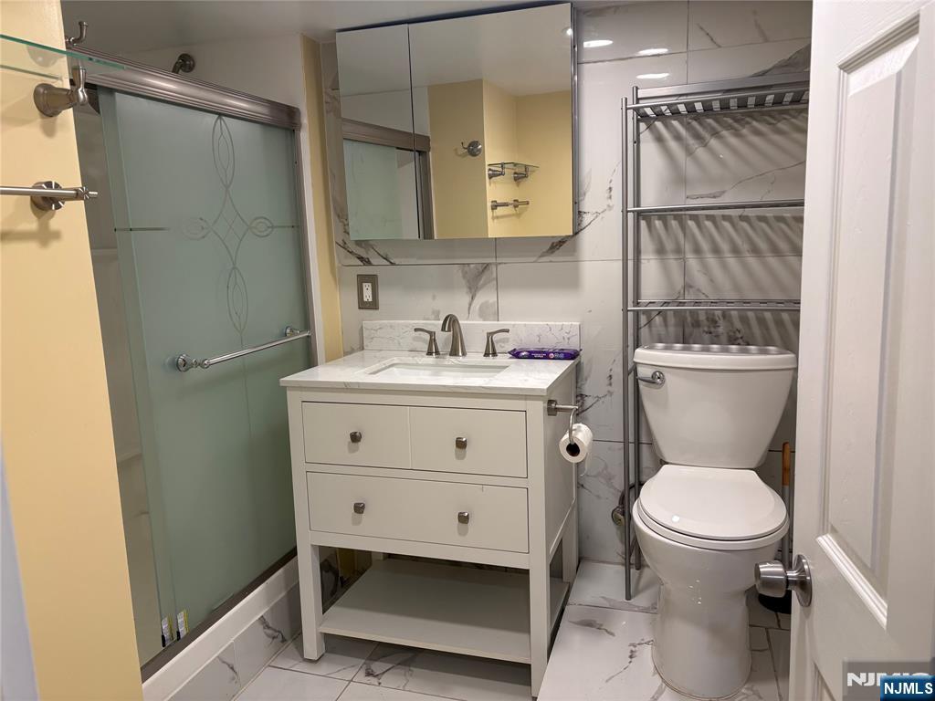 282 Harding Avenue, Unit 1 Teaneck, NJ 07666 - Photo 19 of 21 a bathroom with a sink toilet and shower