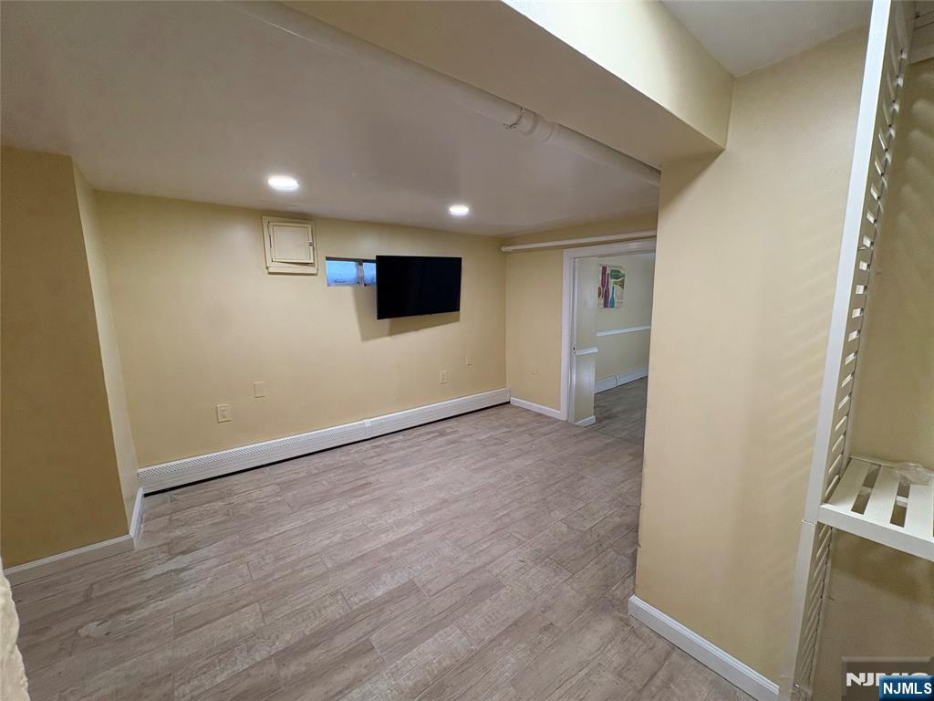 282 Harding Avenue, Unit 1 Teaneck, NJ 07666 - Photo 20 of 21 a view of empty room with wooden floor and fan