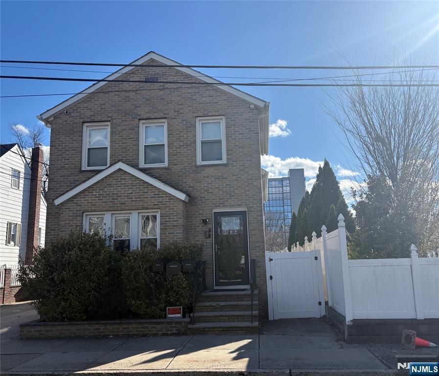282 Harding Avenue, Unit 1 Teaneck, NJ 07666 - Photo 2 of 21 a front view of a house with a yard