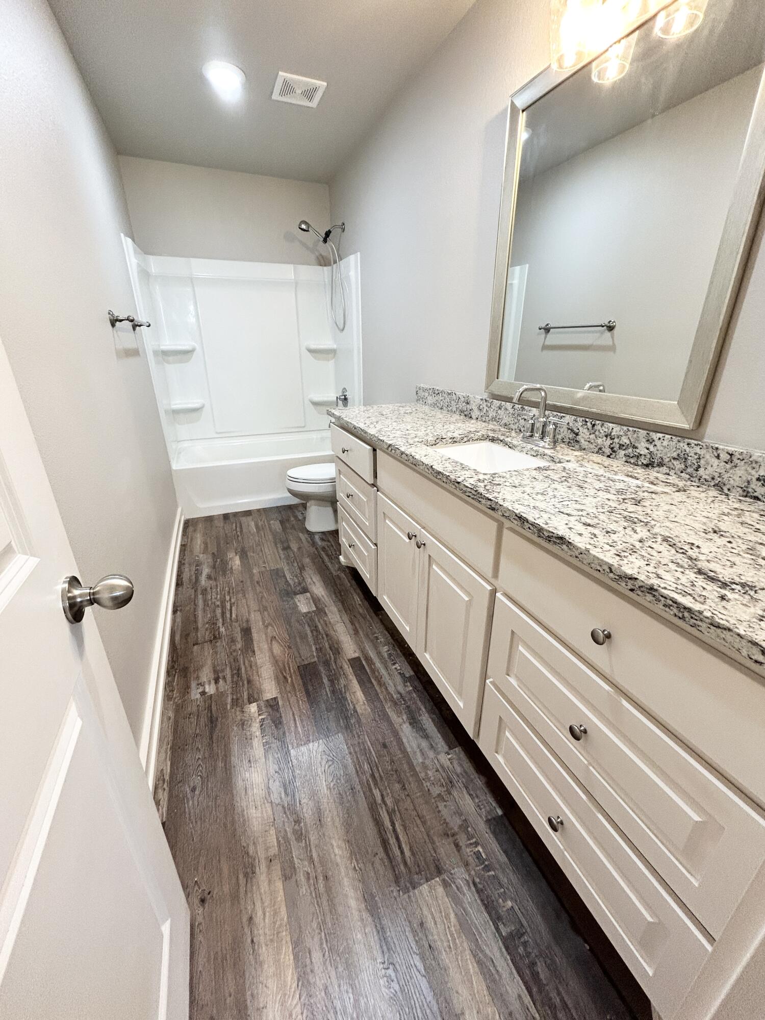 5512 122nd Street, Unit B Lubbock, TX 79424 - Photo 8 of 9 a bathroom with a sink and mirror
