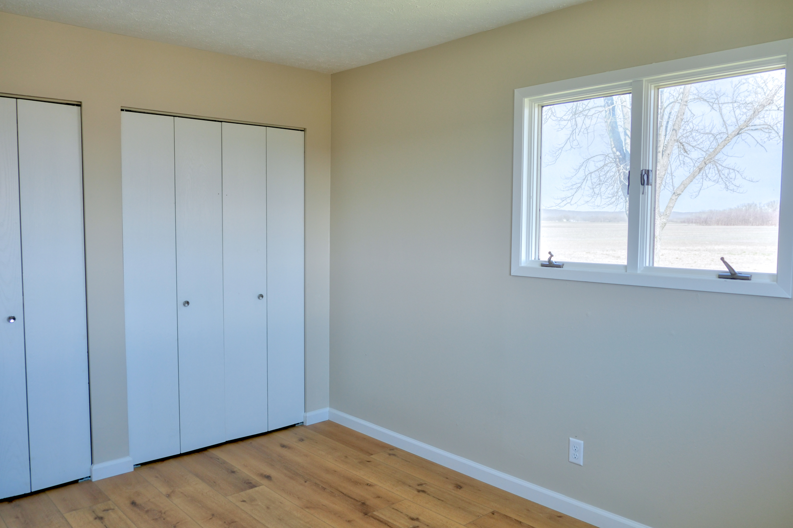 676 Swan Pond Road Jacob, IL 62950 - Photo 14 of 42 a view of an empty room with wooden floor and a window