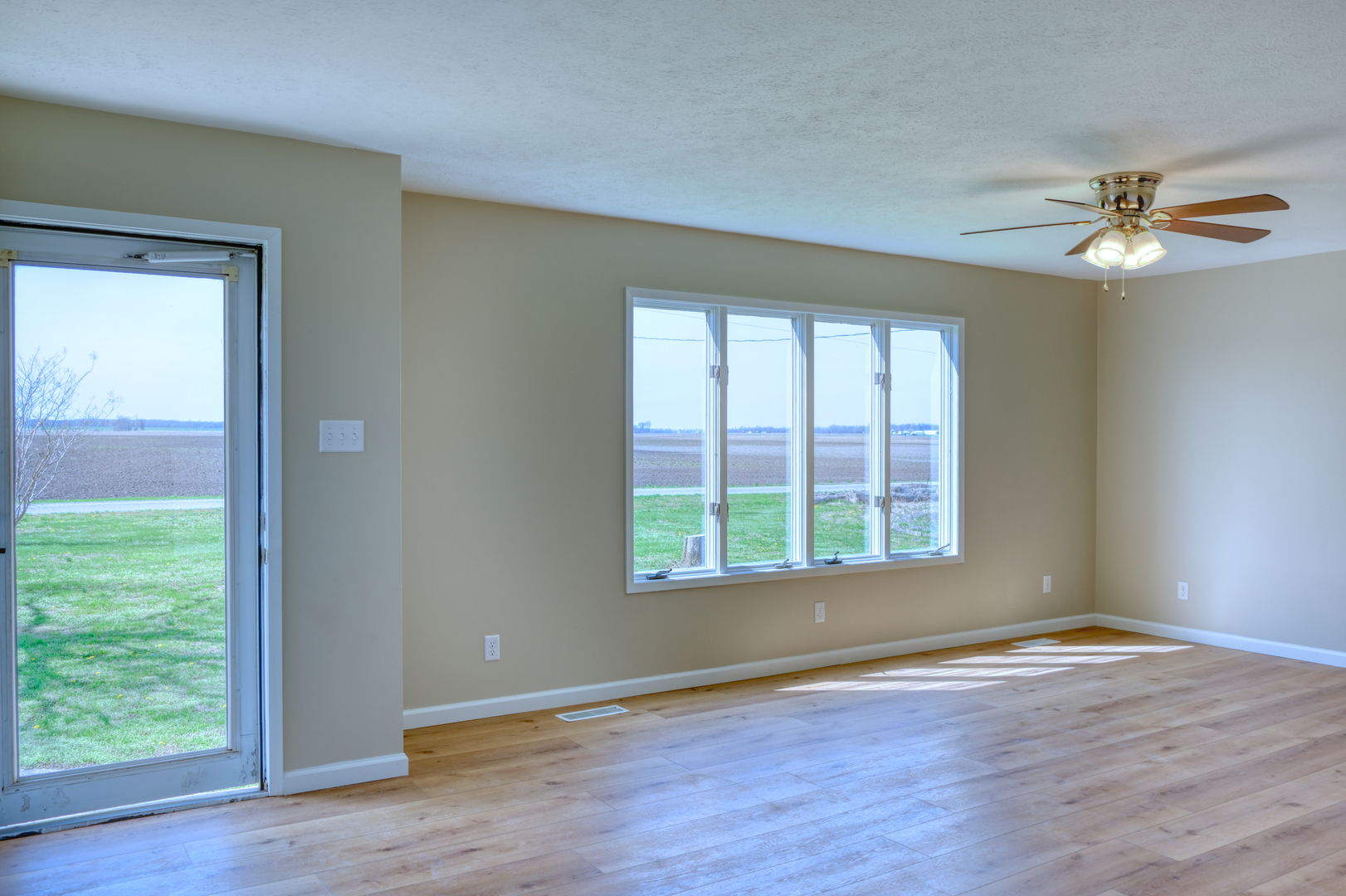 676 Swan Pond Road Jacob, IL 62950 - Photo 2 of 42 a view of an empty room with a window and wooden floor