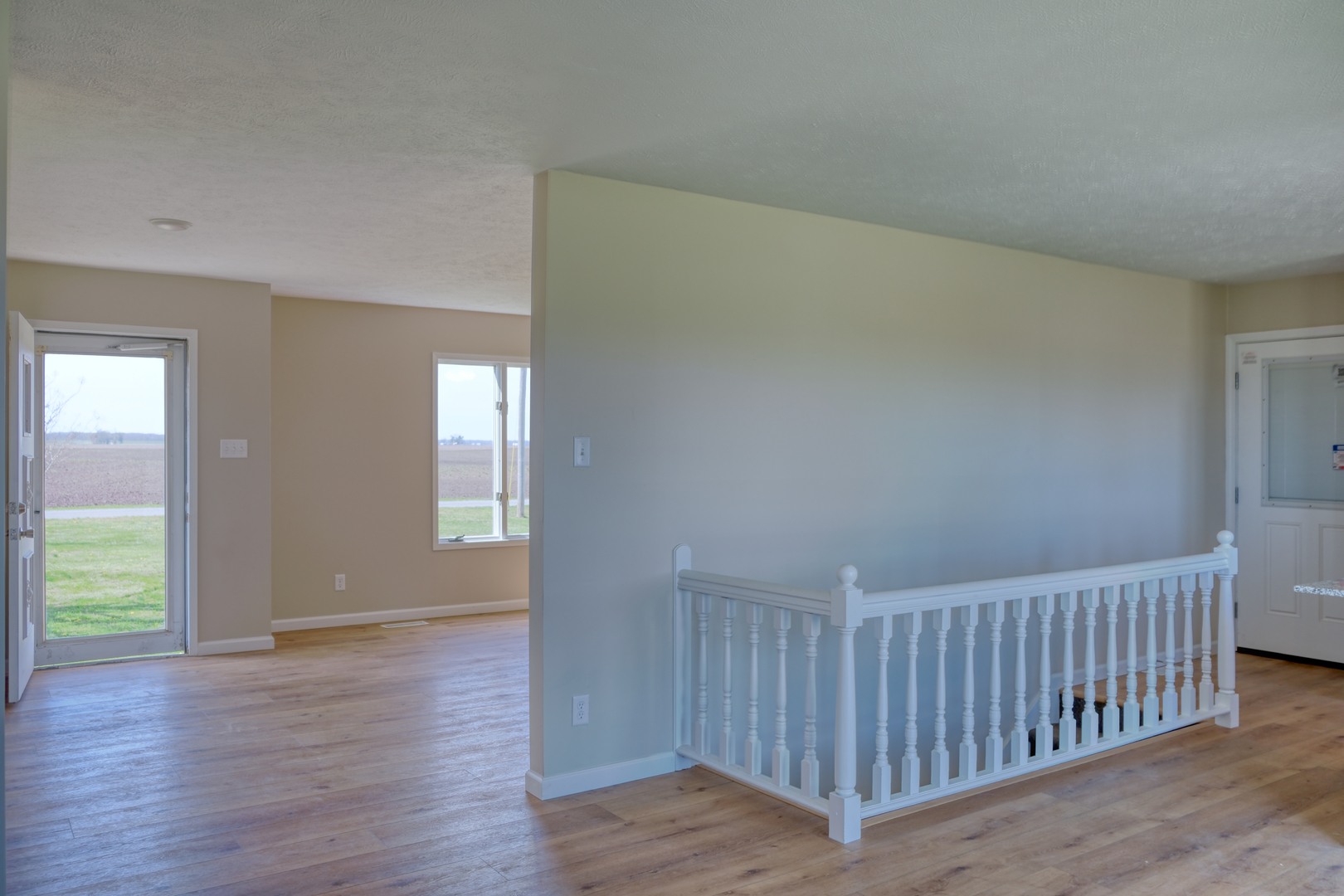 676 Swan Pond Road Jacob, IL 62950 - Photo 3 of 42 a view of an empty room with wooden floor and windows