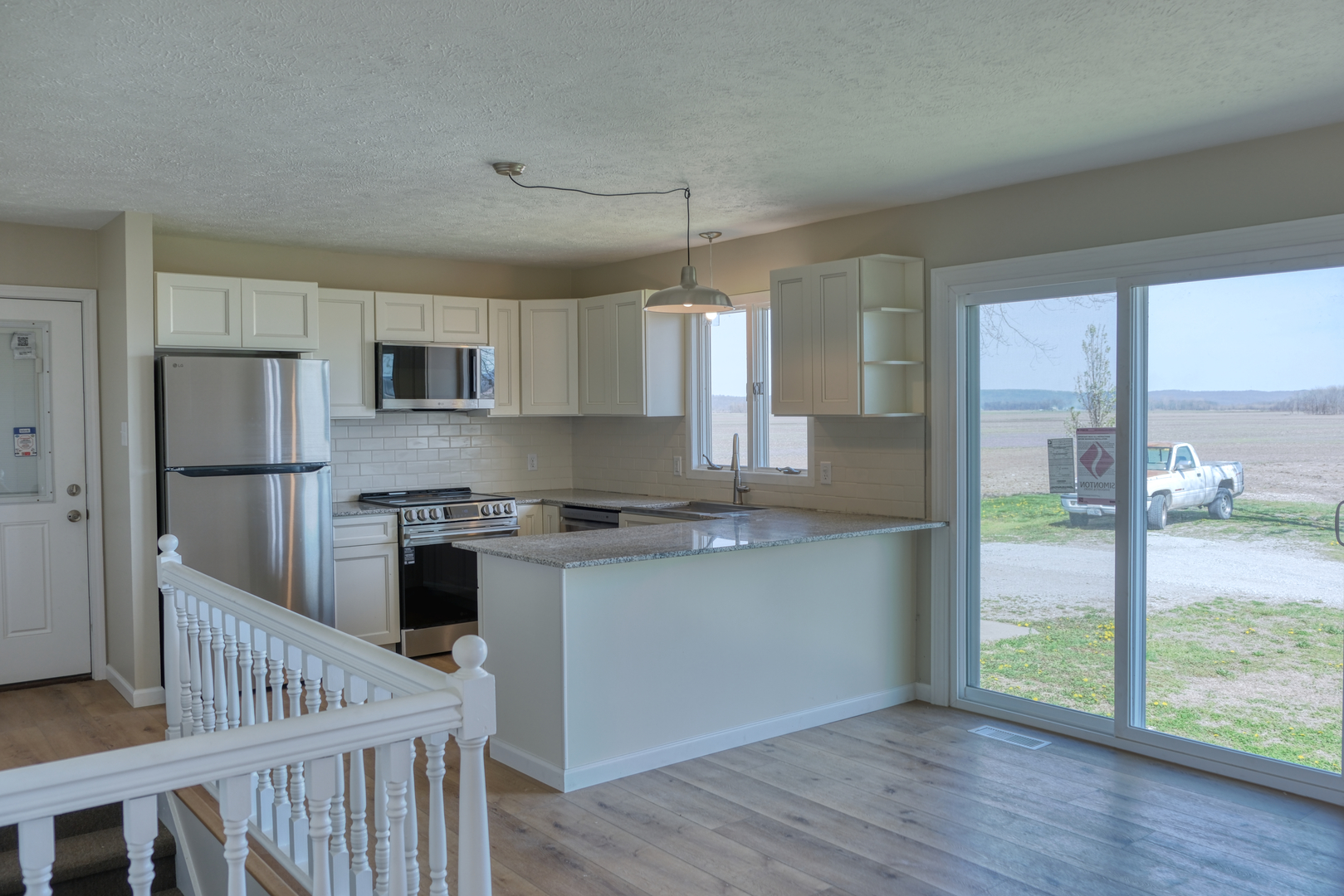 676 Swan Pond Road Jacob, IL 62950 - Photo 5 of 42 a kitchen with stainless steel appliances granite countertop a refrigerator a stove a sink dishwasher and white cabinets with wooden floor
