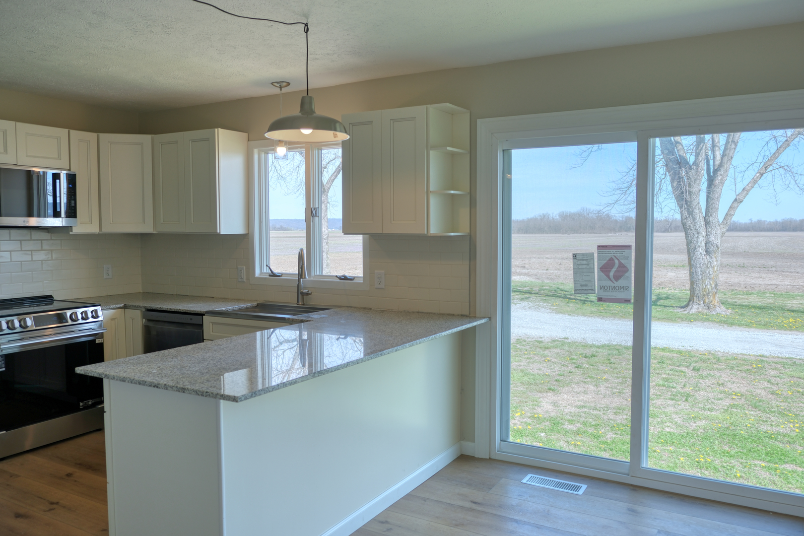 676 Swan Pond Road Jacob, IL 62950 - Photo 6 of 42 a kitchen with stainless steel appliances granite countertop a sink a stove and a wooden floors