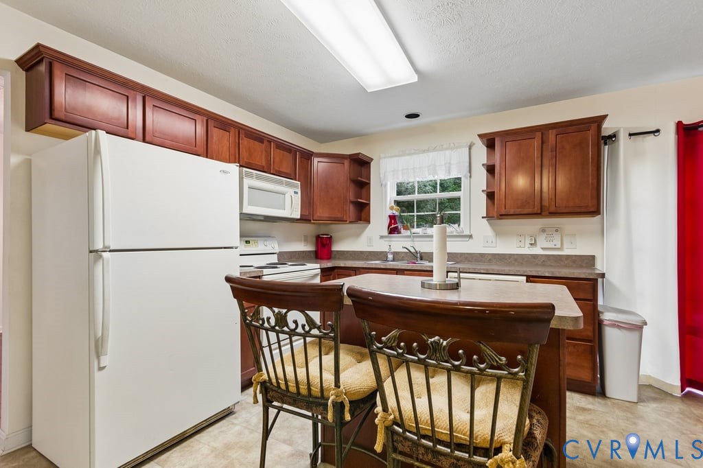 83 Albertson Court Ruther Glen, VA 22546 - Photo 8 of 25 Kitchen featuring wood-finish cabinetry, a freesta
