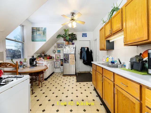 a kitchen with stainless steel appliances kitchen island granite countertop a sink a counter space and a window