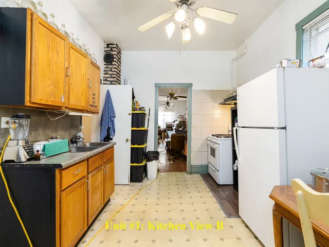 a kitchen with refrigerator and cabinets