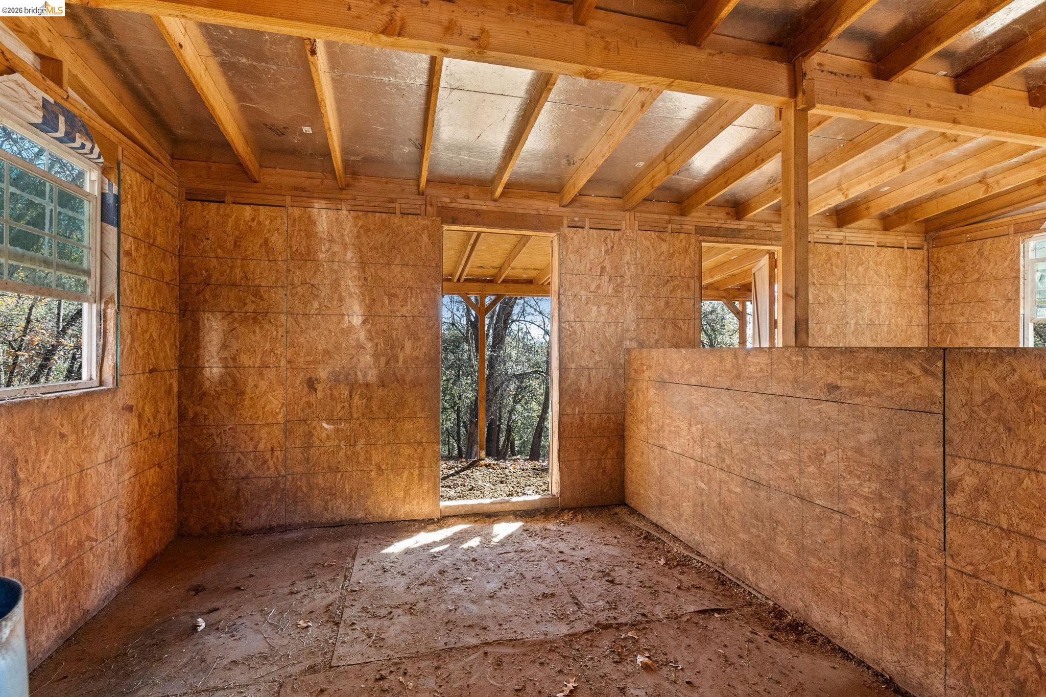 16144 Big Hill Road Sonora, CA 95370 - Photo 41 of 51 Interior framing featuring visible wood beams and subflooring