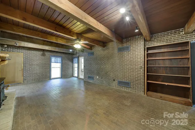 a view of empty room with a fireplace