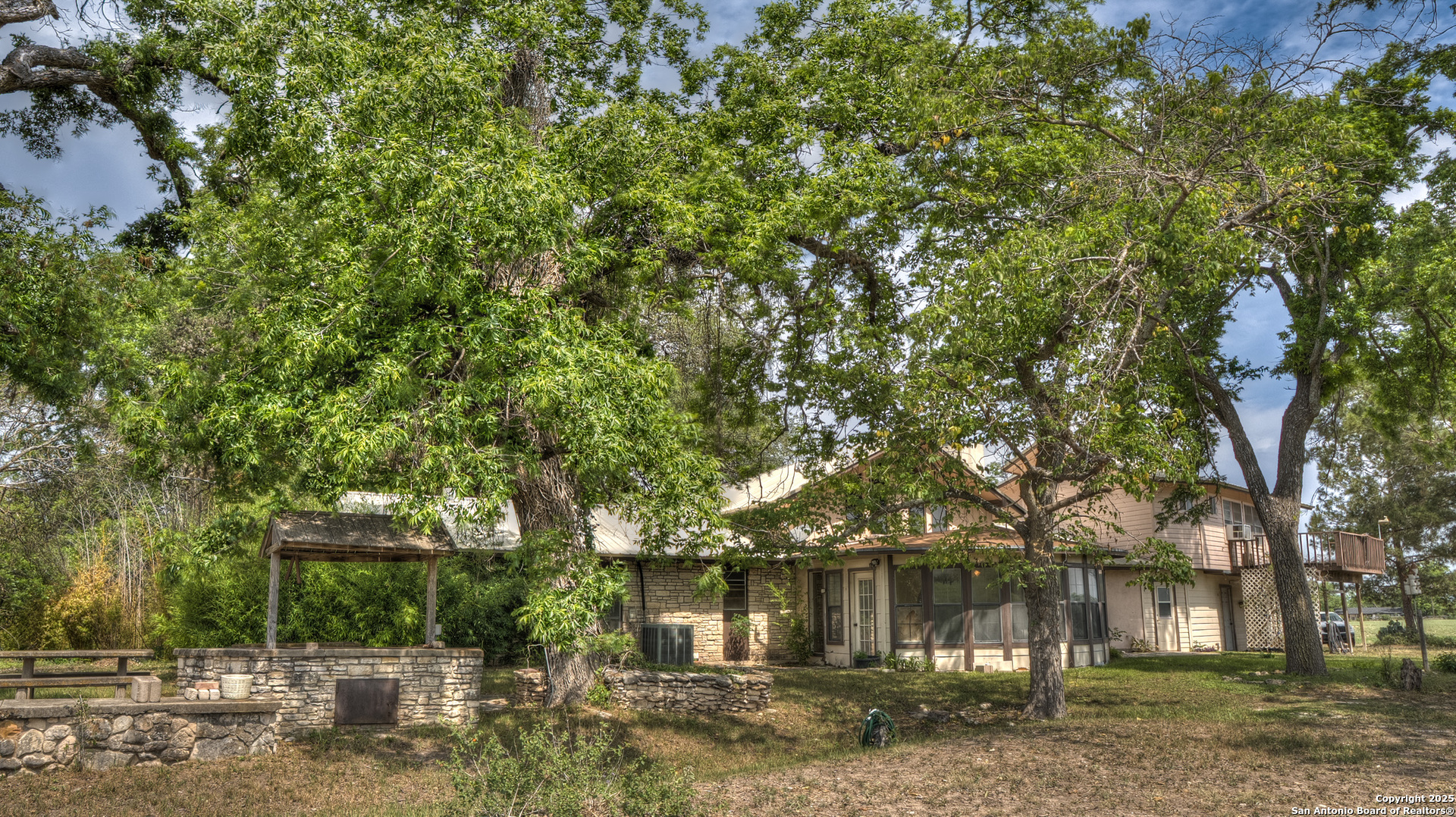 6671 Ranch Road 1120 Rio Frio, TX 78879 - Photo 15 of 47 a front view of a house with a garden