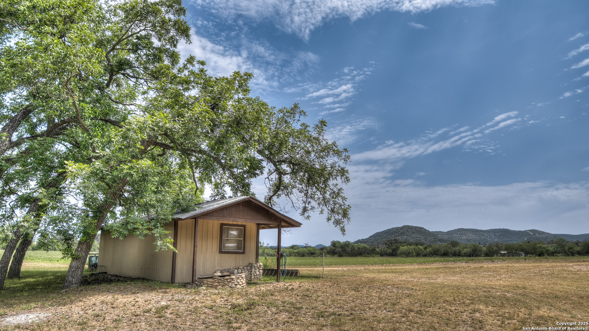6671 Ranch Road 1120 Rio Frio, TX 78879 - Photo 19 of 47 a front view of a house with a garden and lake view