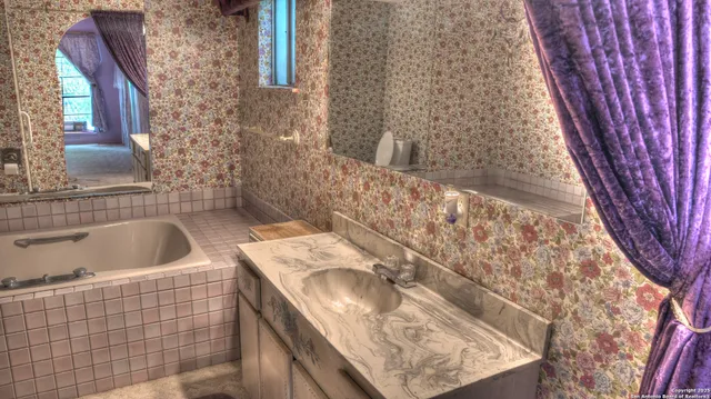 a bathroom with a bathtub and shower