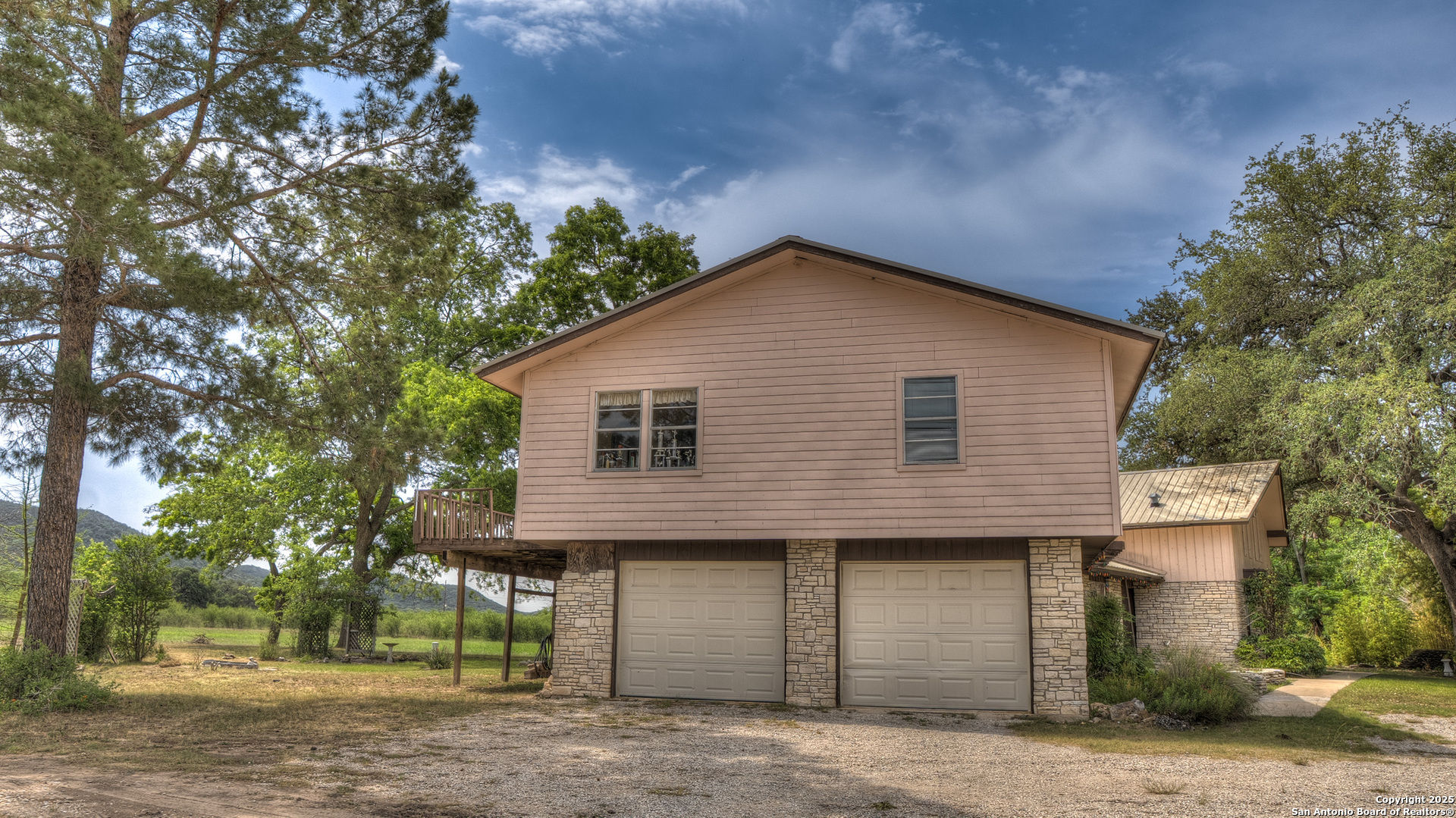 6671 Ranch Road 1120 Rio Frio, TX 78879 - Photo 9 of 47 a front view of a house with a garden