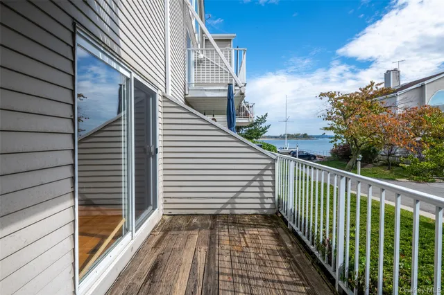 a view of a balcony with wooden floor and fence