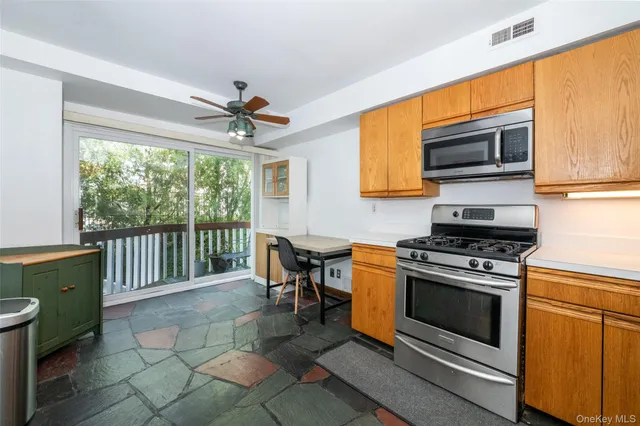 a kitchen with a stove a sink and a microwave