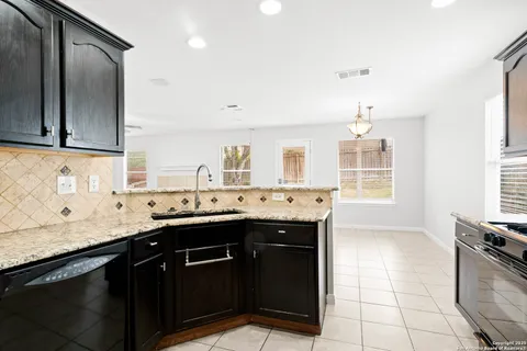 a kitchen with a sink a stove and cabinets