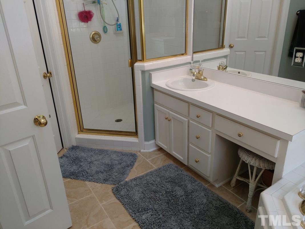9425 Stone Mountain Road Raleigh, NC 27613 - Photo 23 of 25 a bathroom with a sink and a mirror