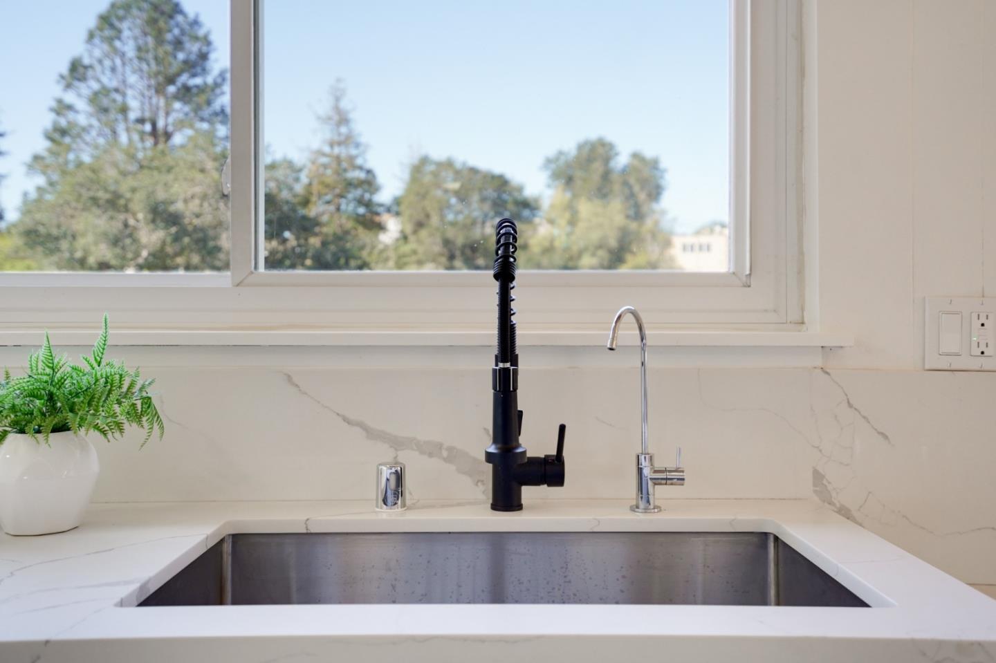 4615 Redding Street Oakland, CA 94619 - Photo 13 of 49 a view of a sink a counter top and a potted plant