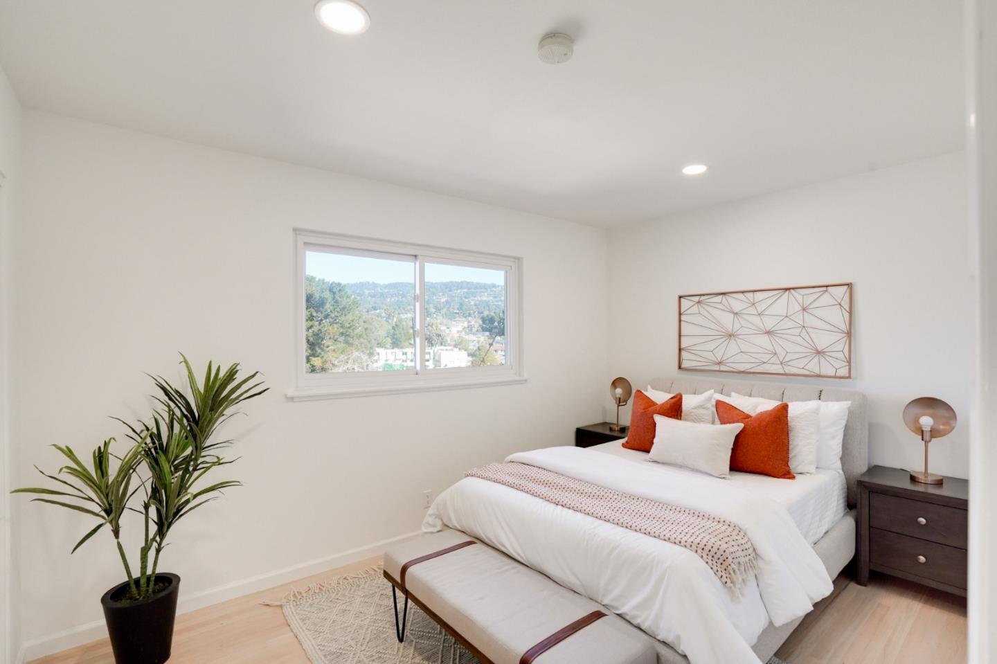 4615 Redding Street Oakland, CA 94619 - Photo 20 of 49 a bedroom with a large bed and a potted plant