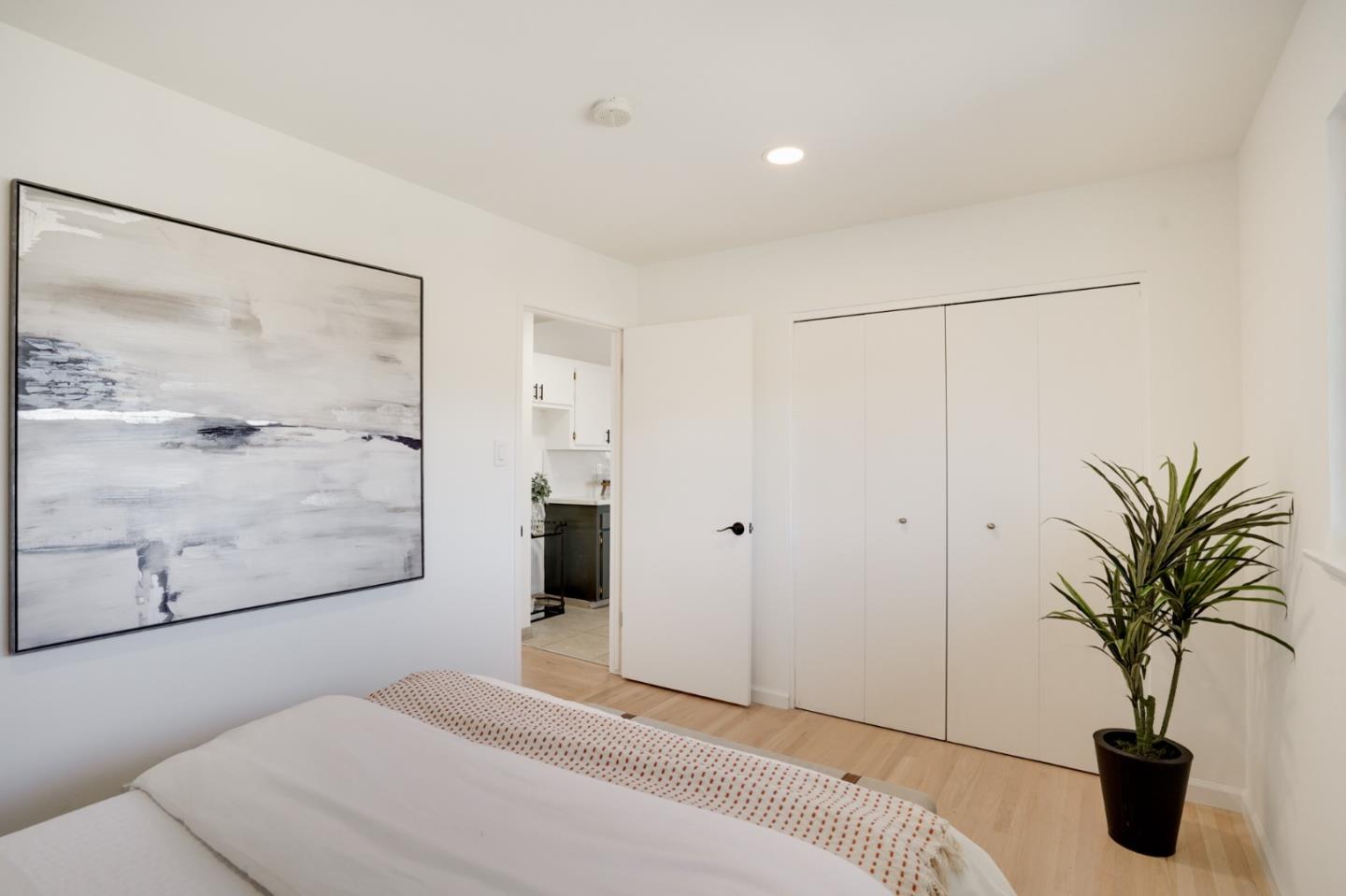 4615 Redding Street Oakland, CA 94619 - Photo 21 of 49 a bedroom with a large bed and a potted plant