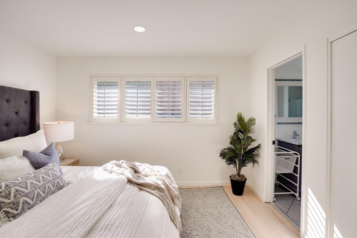 4615 Redding Street Oakland, CA 94619 - Photo 27 of 49 a bedroom with a bed and a potted plant