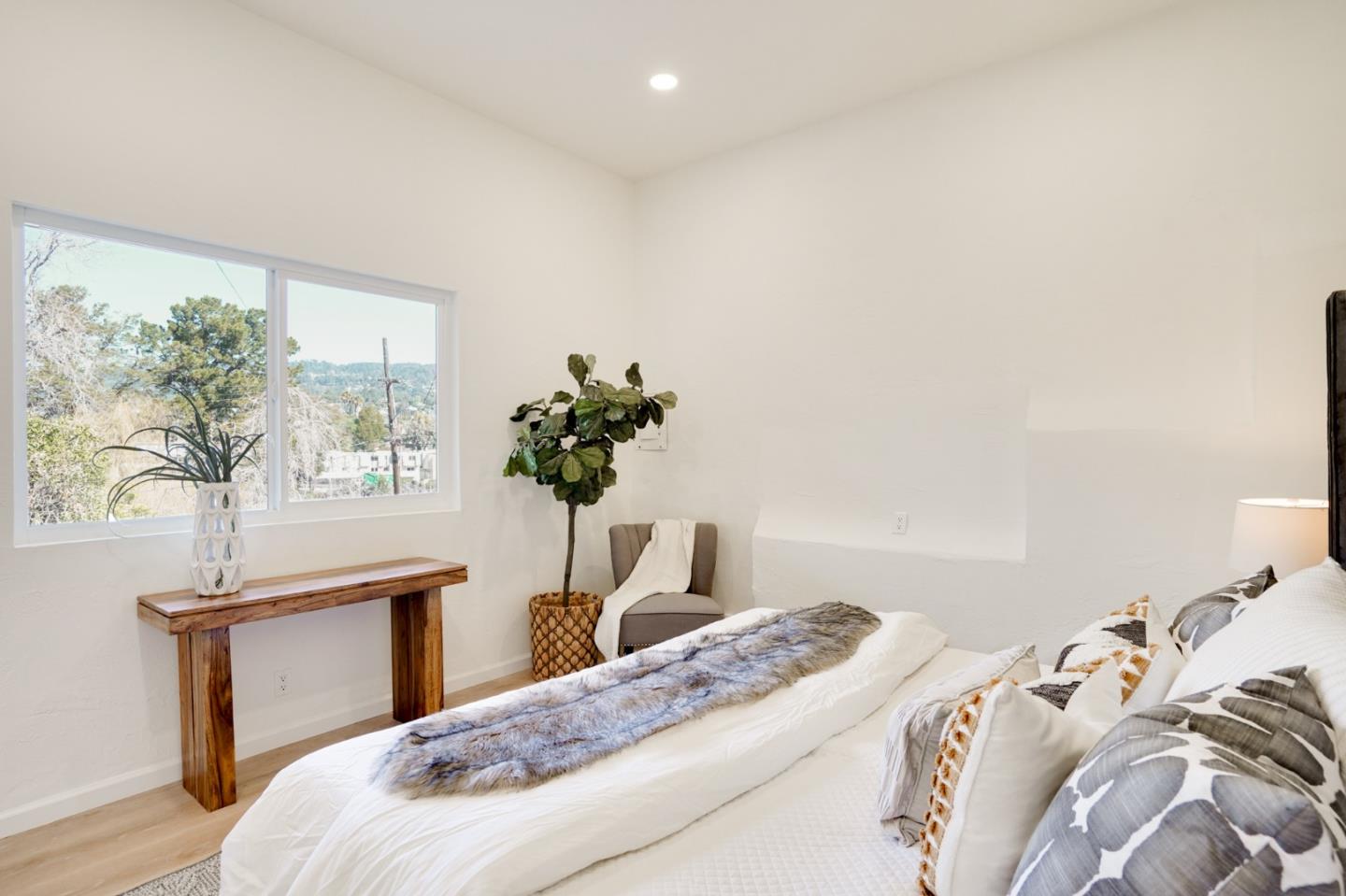 4615 Redding Street Oakland, CA 94619 - Photo 30 of 49 a bedroom with a bed and a potted plant