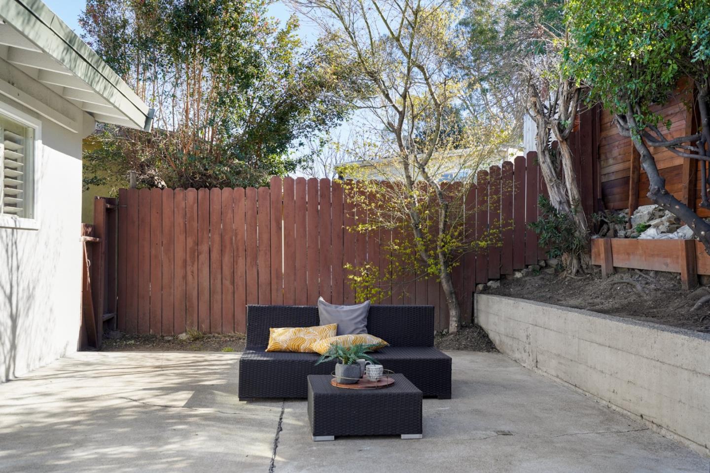 4615 Redding Street Oakland, CA 94619 - Photo 37 of 49 a view of a patio with couches and a fire pit and large trees