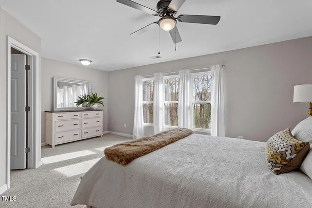 a bedroom with a large bed and a window