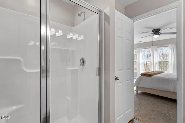 a en suite bathroom with a shower and a sink