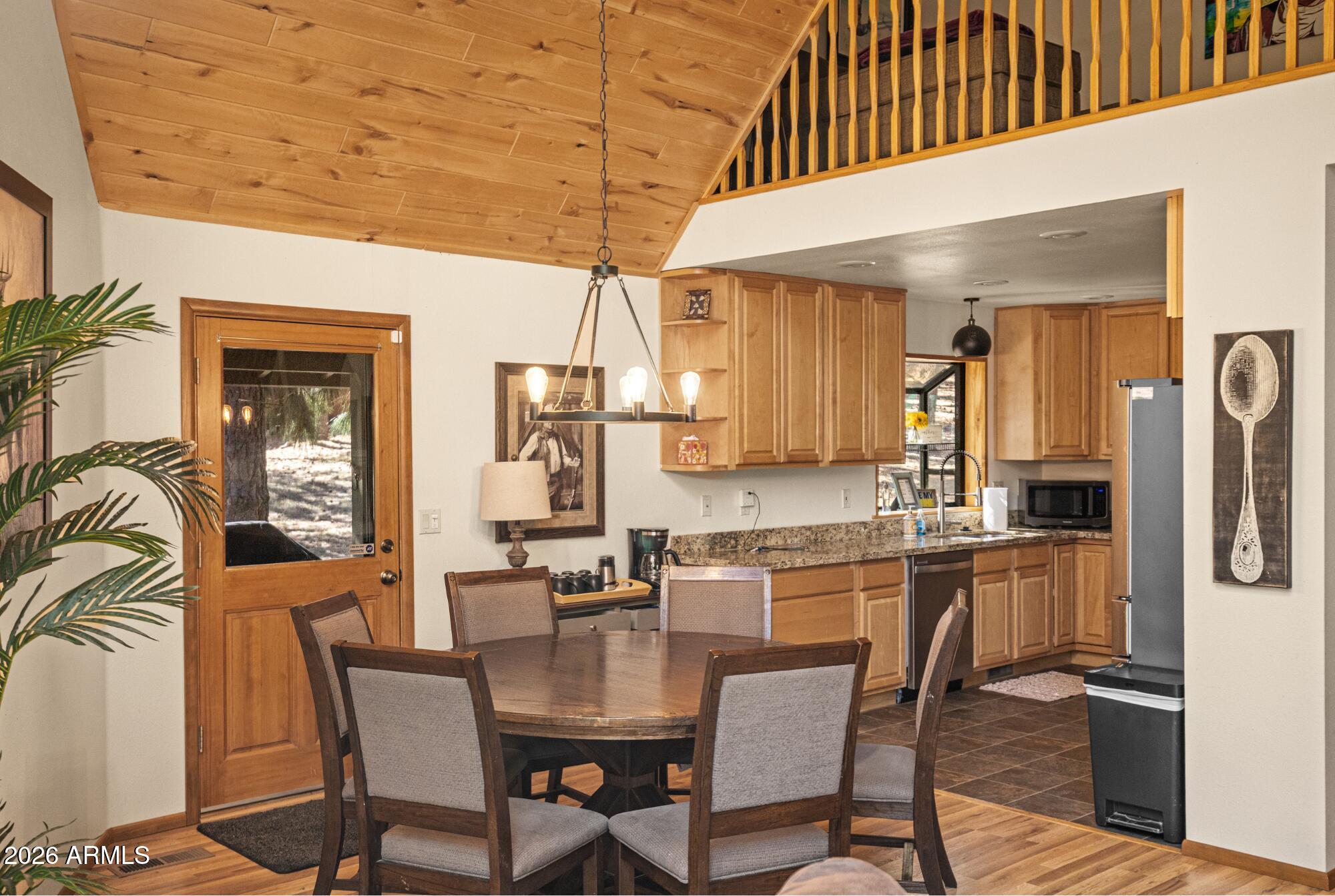 628 Trout Springs Road Forest Lakes, AZ 85931 - Photo 11 of 49 a dining hall with stainless steel appliances kitchen island granite countertop a table chairs and a view of kitchen